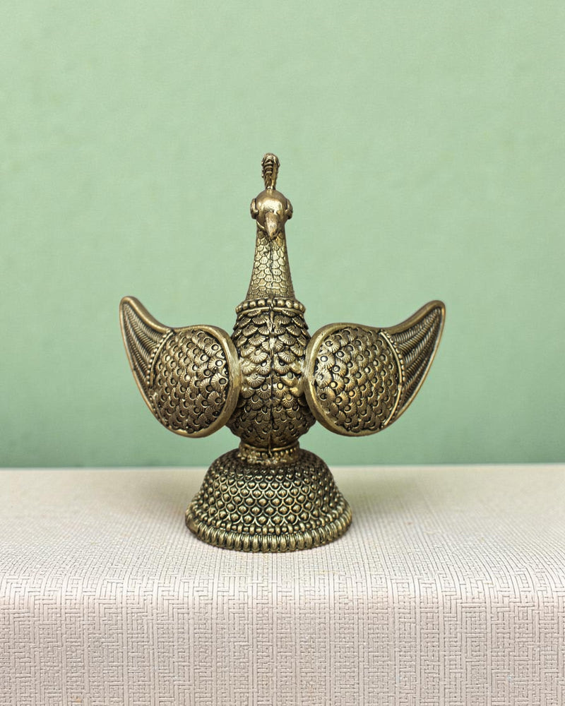 Rigvedaa™ brass swan statue with intricately carved fan wings and textured base. Golden patina finish.
