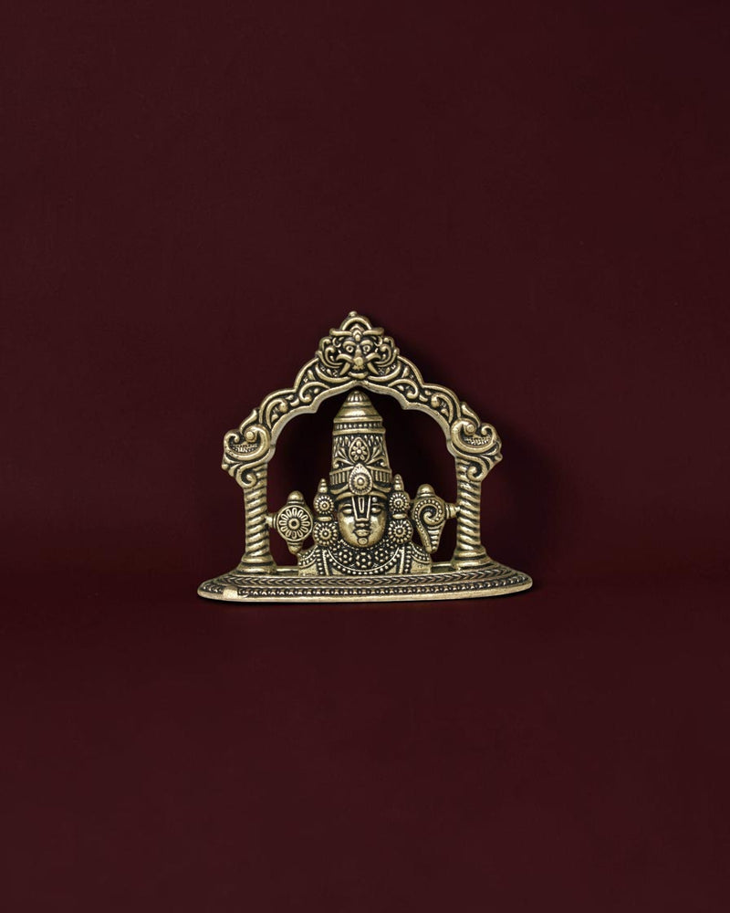 Rigvedaa™ brass Lord Venkateswara Tirupati Balaji face idol with intricate crown detailing on a dark background