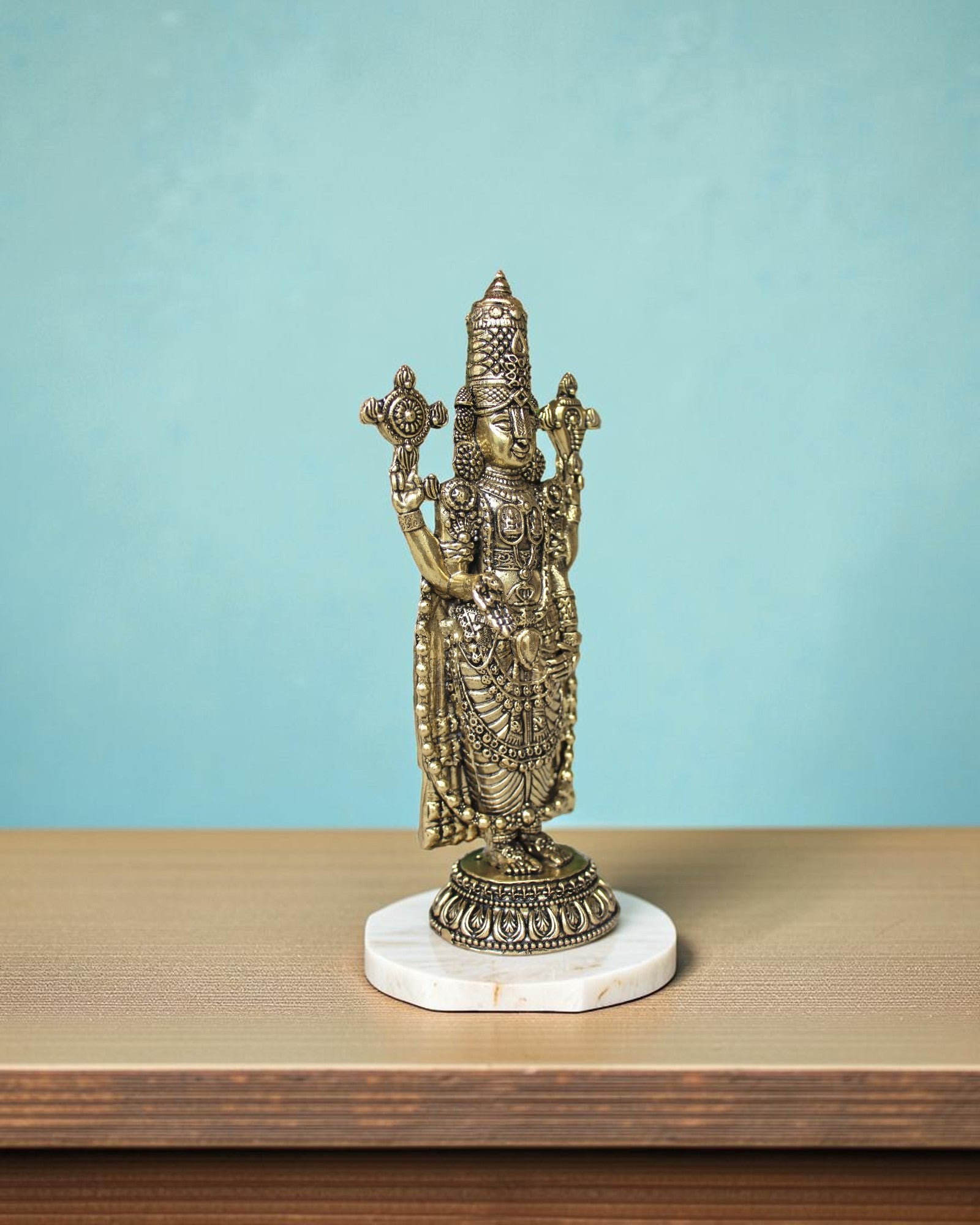 Rigvedaa

Brass Lord Venkateshwara Tirupati Balaji standing idol, 6.5" tall, holding conch and discus.