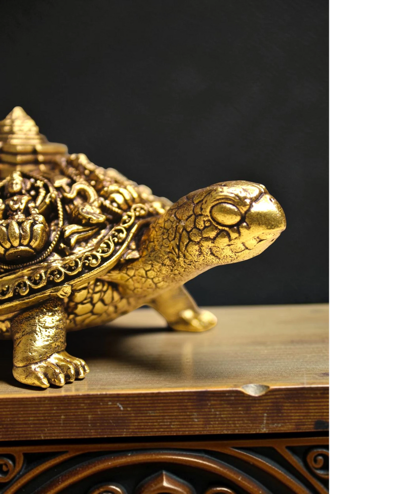 Rigvedaa™ golden brass tortoise figurine with intricate Ashta Lakshmi and Shree Yantra engravings, symbolizing prosperity and good fortune.