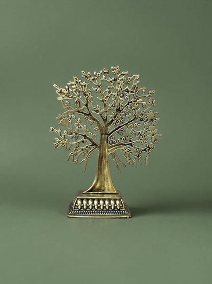 Rigvedaa™ brass Tree of Life tabletop sculpture with intricate branches, leaves, and bird accents on an ornate base.