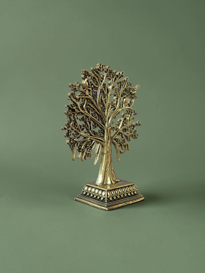 Rigvedaa™ brass Tree of Life tabletop sculpture with intricate branches, leaves, and bird accents on a square base.