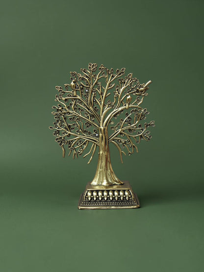 Rigvedaa™ brass Tree of Life tabletop sculpture with intricate branches, leaves, and bird accents on an ornate base.