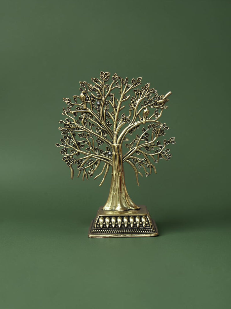 Rigvedaa™ brass Tree of Life tabletop sculpture with intricate branches, leaves, and bird accents on an ornate base.