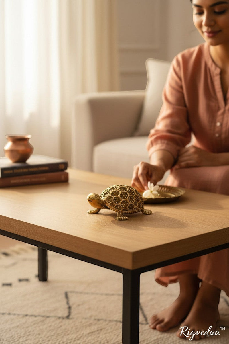 Rigvedaa brass Vastu tortoise figurine with intricate hexagonal pattern on shell, placed on a wooden table.