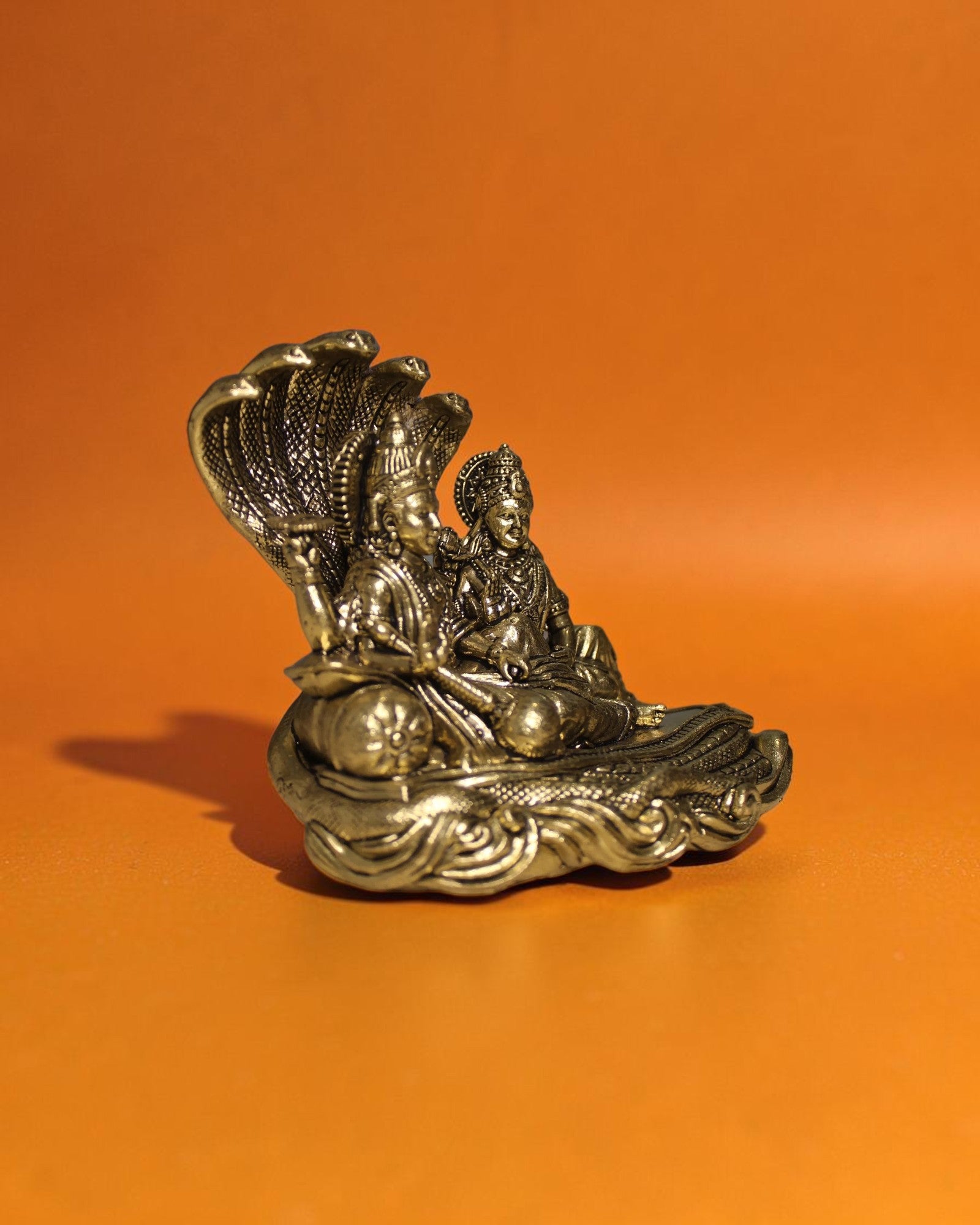 Rigvedaa	rade	rade Brass Vishnu Lakshmi Sheshnag idol, golden patina, intricate details, 4.25 inches.