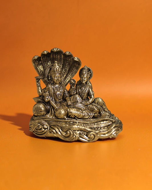 Rigvedaa Brass Vishnu Lakshmi Sheshnag statue, golden patina, intricate details, 4.25 inches tall, for wealth and protection.