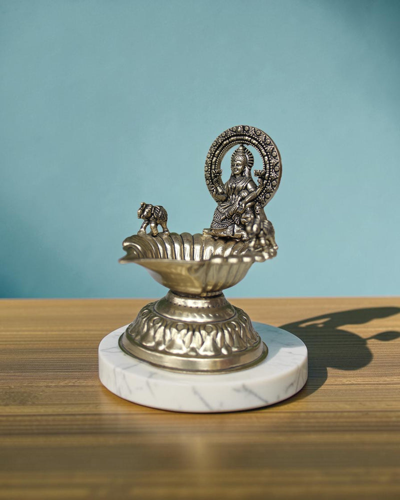 Rigvedaa™ Handcrafted brass Gaj Laxmi diya oil lamp with intricate details and antique finish. 4.5 inch.