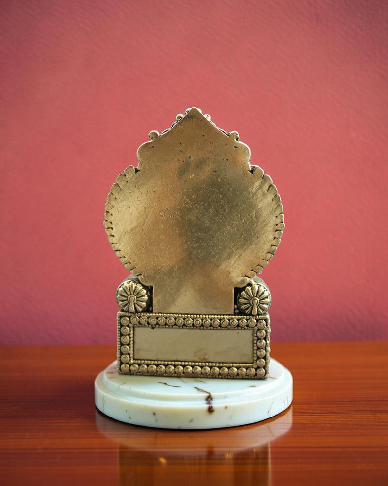 Rigvedaa™ antique brass Ganesha statue seated on an ornate throne, detailed carvings, spiritual decor.