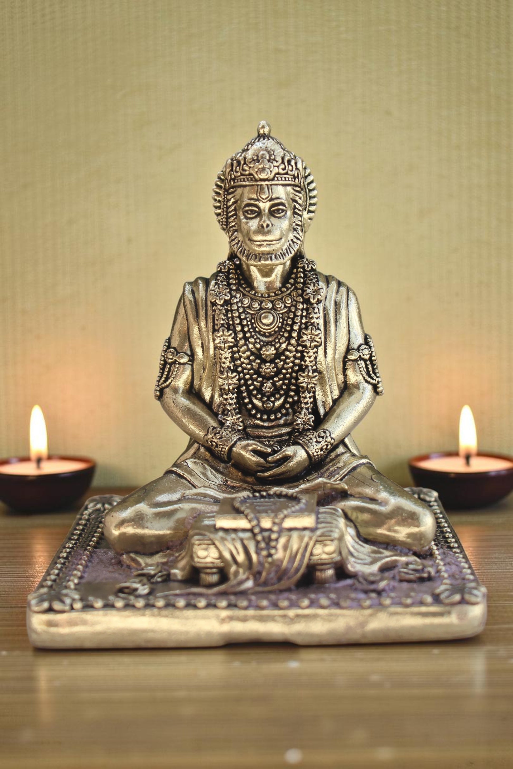Rigvedaa brass idol of Lord Hanuman meditating in Ram Sadhna posture, adorned with necklaces, seated on a decorative base.