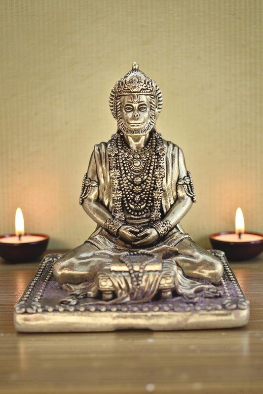 Rigvedaa brass idol of Lord Hanuman meditating in Ram Sadhna posture, adorned with necklaces, seated on a decorative base.
