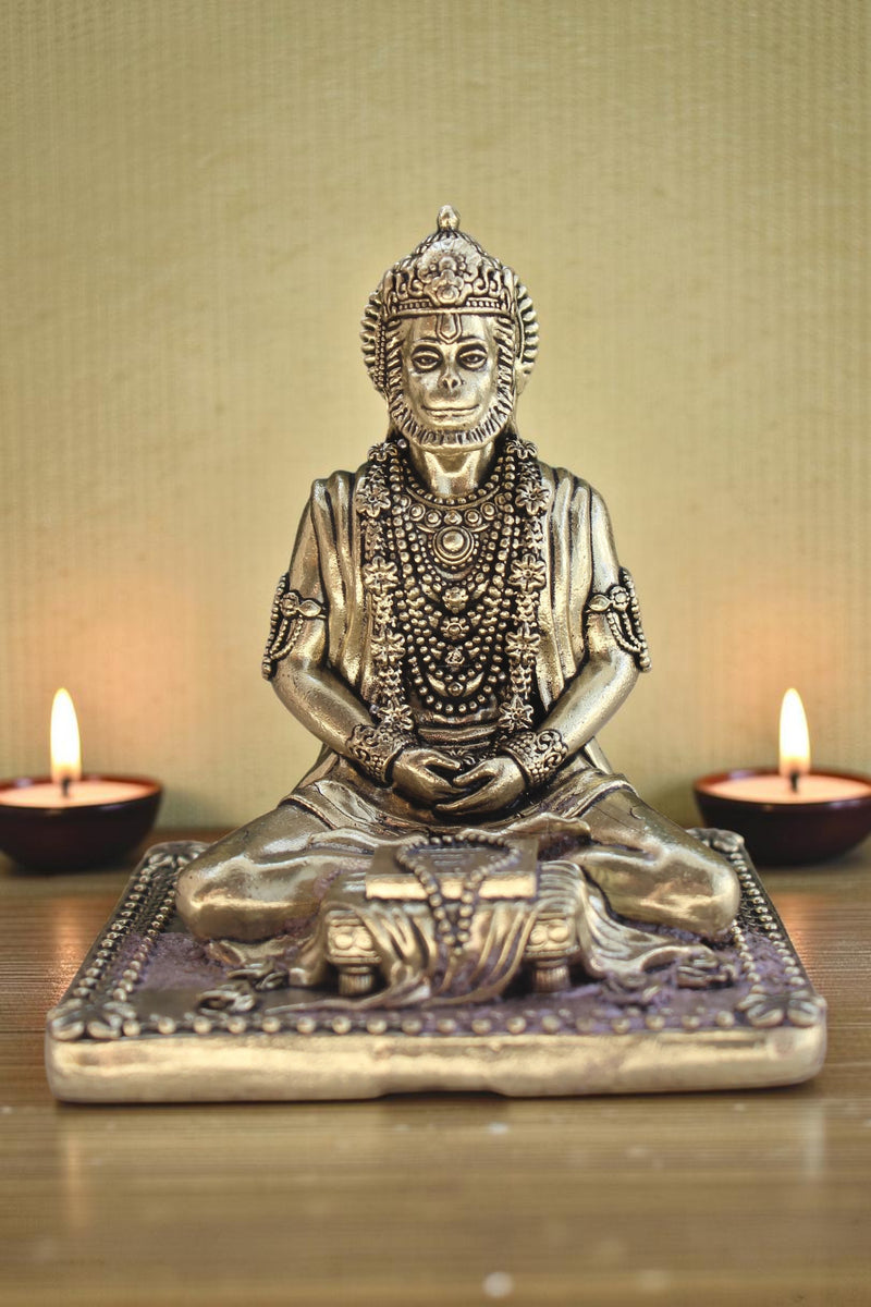 Rigvedaa brass idol of Lord Hanuman meditating in Ram Sadhna posture, adorned with necklaces, seated on a decorative base.