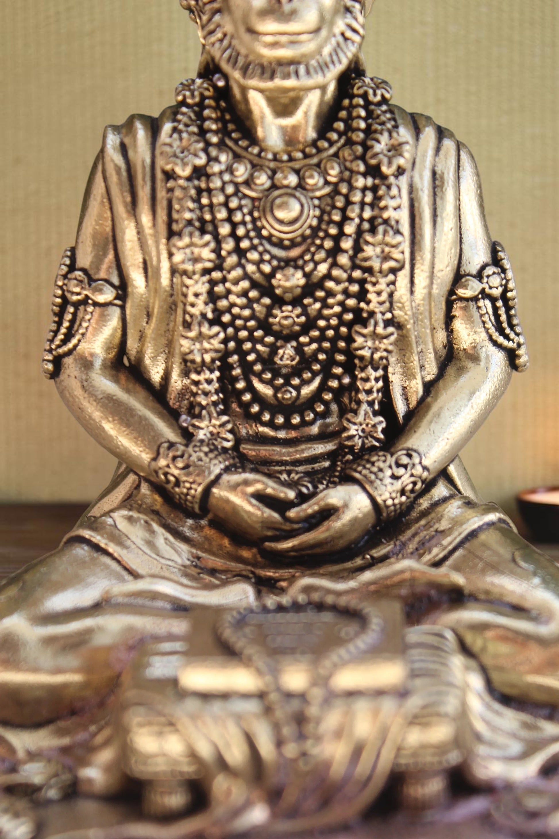 Rigvedaa brass idol of Lord Hanuman meditating in Ram Sadhna posture, adorned with intricate necklaces and bracelets.