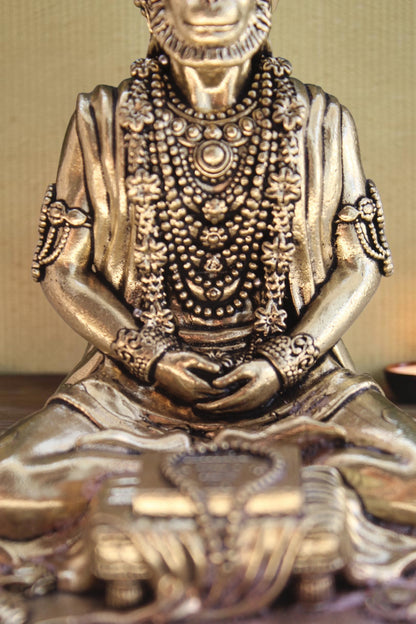 Rigvedaa brass idol of Lord Hanuman meditating in Ram Sadhna posture, adorned with intricate necklaces and bracelets.