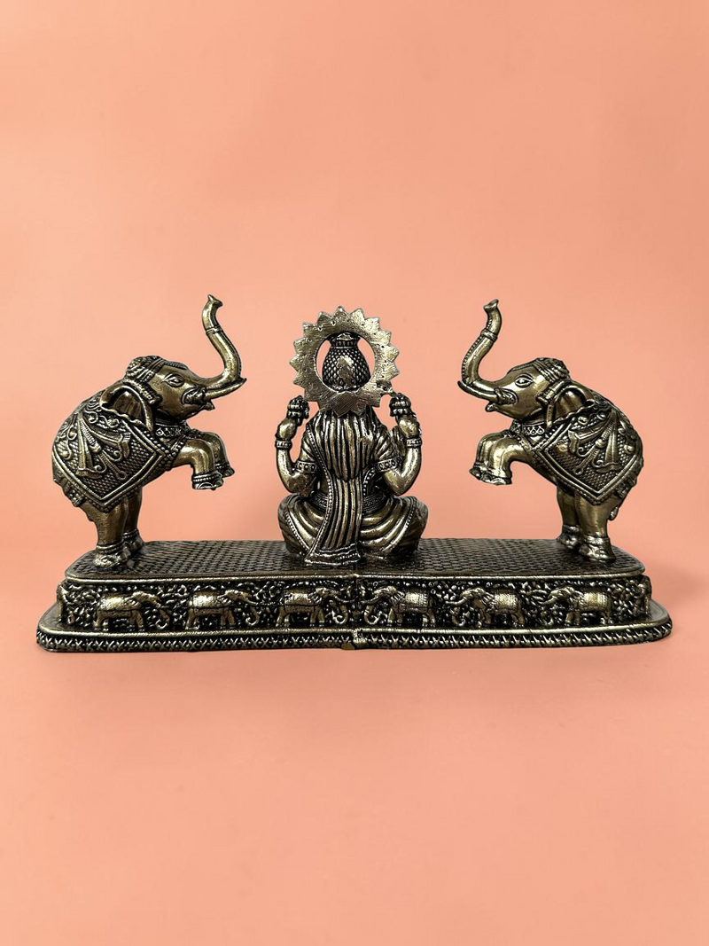 Rigvedaa™ Goddess Lakshmi and elephants decorative figurine in antique bronze finish with intricate base detailing.