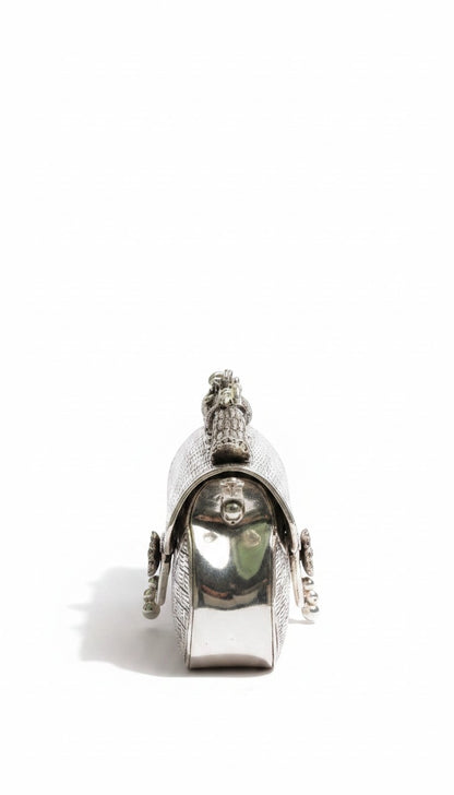 Rigvedaa™ Leela silver plated brass clutch with intricate carvings and a top handle. Ideal for formal events.