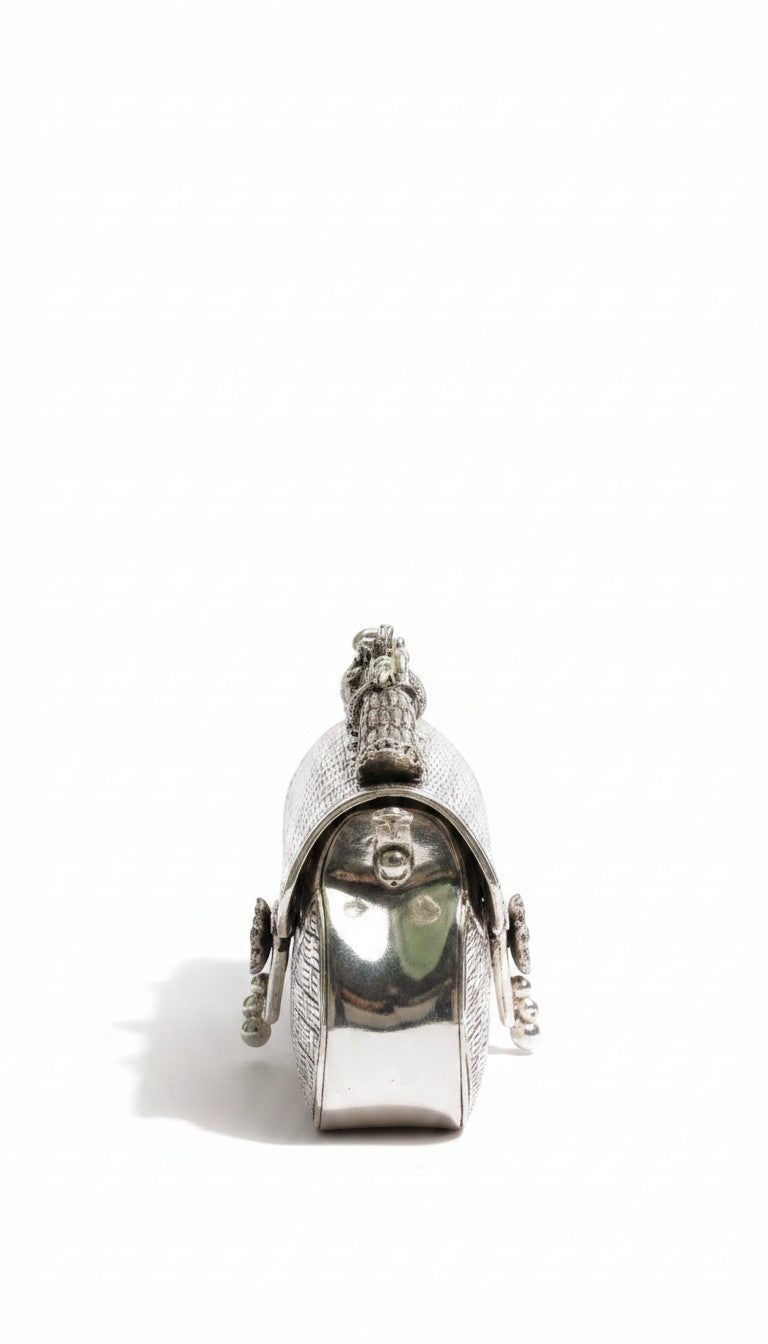 Rigvedaa™ Leela silver plated brass clutch with intricate carvings and a top handle. Ideal for formal events.