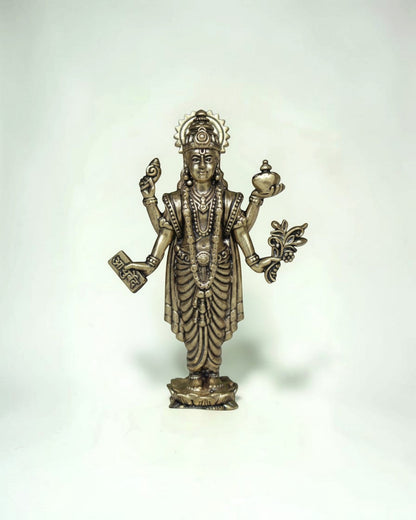 Rigvedaa™ Lord Dhanvantri brass idol, God of Ayurveda, holding a pot and herbs for health and healing.