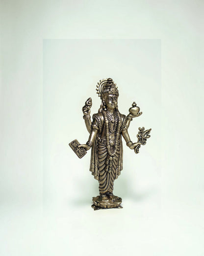 Rigvedaa Lord Dhanvantri brass idol, God of Ayurveda, holding a book and pot. For health and healing.