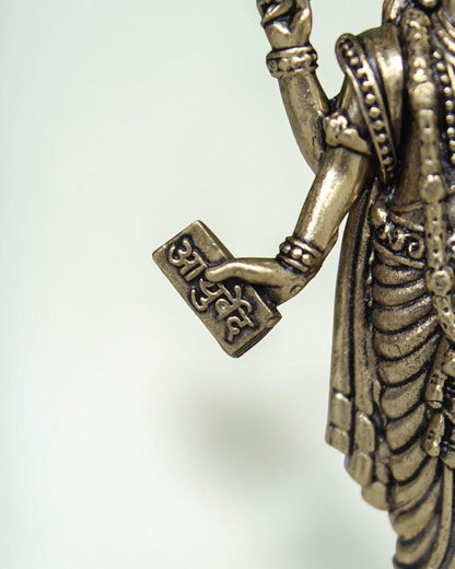 Rigvedaa Lord Dhanvantri brass idol, God of Ayurveda, holding a sacred text. Traditional detailing.