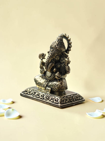 Rigvedaa™ decorative Lord Ganesha idol with an antique gold finish, featuring intricate engravings on a pedestal.