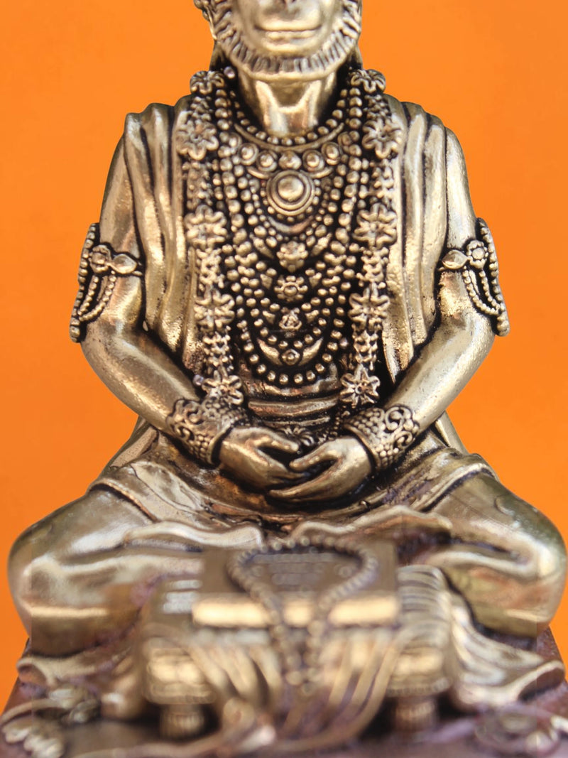 Rigvedaa™ Lord Hanuman meditating brass statue in a serene seated posture with intricate jewelry and golden patina finish.
