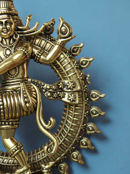 Rigvedaa™ golden brass Nataraja statue detail showing intricate floral sash and prabhamandala ring of fire