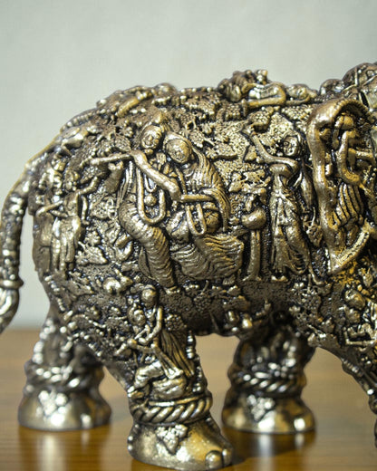 Rigvedaa brass elephant statue with intricate Radha Krishna murals, golden finish, detailed Indian craftsmanship for puja and decor.