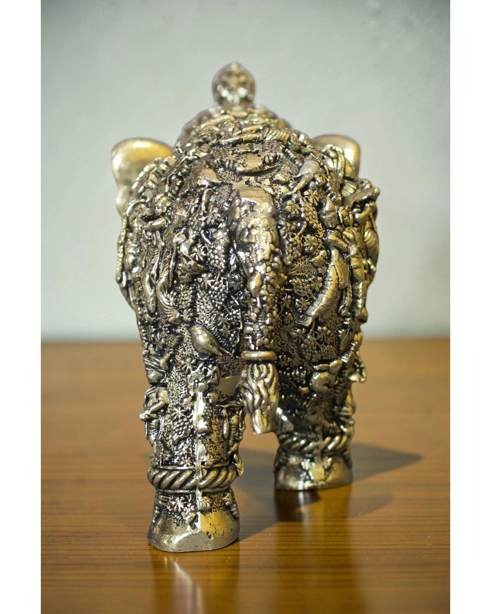 Rigvedaa brass elephant statue adorned with intricate Radha Krishna murals, golden finish, for puja and decor.