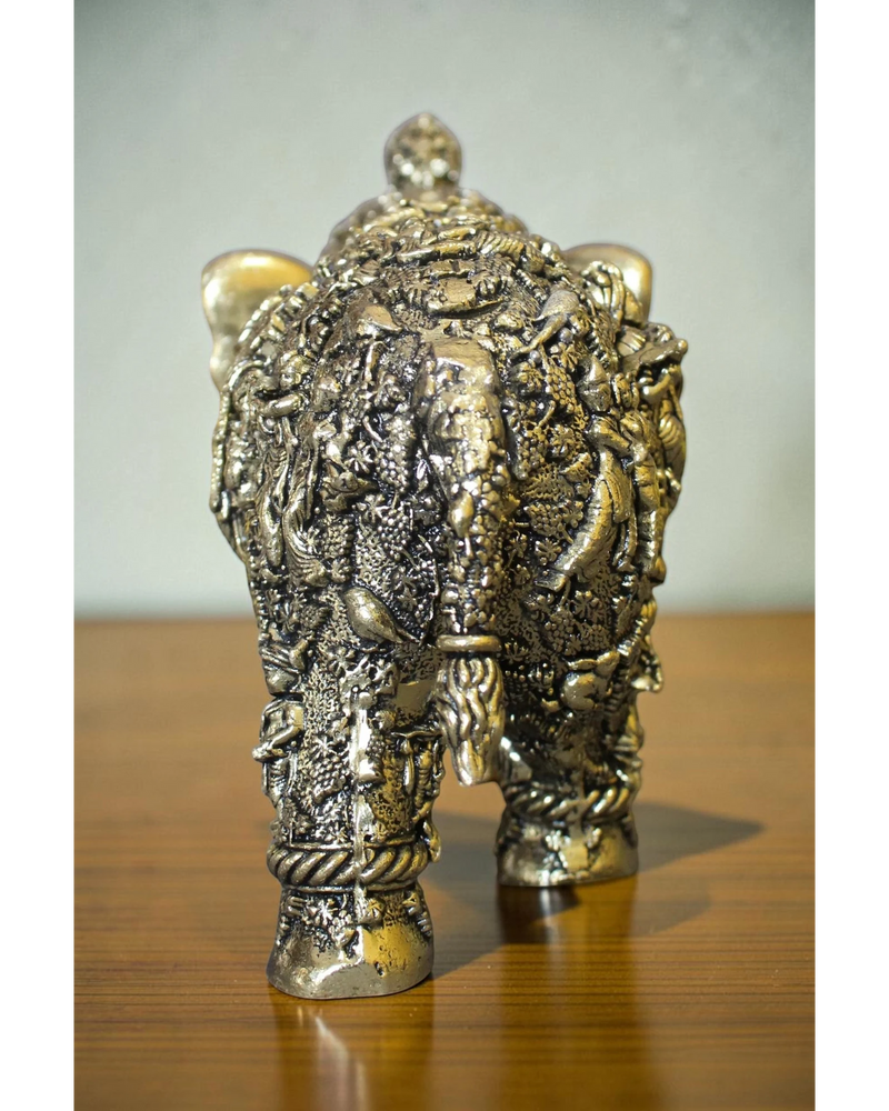 Rigvedaa brass elephant statue adorned with intricate Radha Krishna murals, golden finish, for puja and decor.