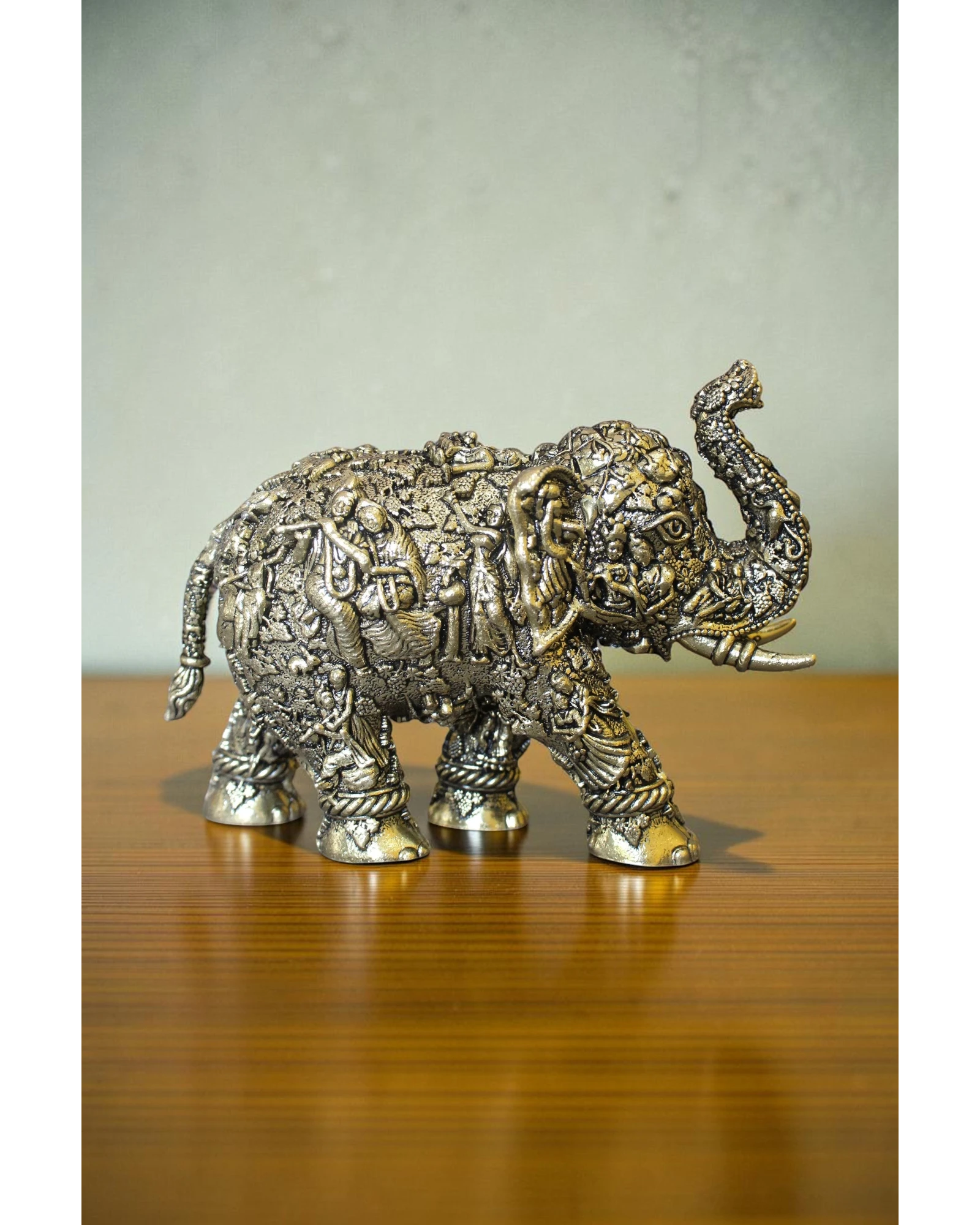 Rigvedaa brass elephant statue with intricate Radha Krishna murals, golden finish, detailed craftsmanship, for puja and decor.