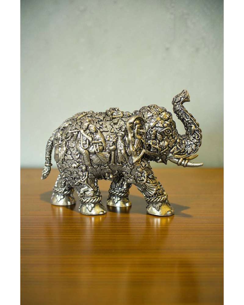 Rigvedaa brass elephant statue with intricate Radha Krishna murals, golden finish, detailed craftsmanship, for puja and decor.