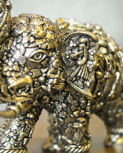 Rigvedaa brass elephant statue with intricate Radha Krishna murals, golden finish, for puja and decor.