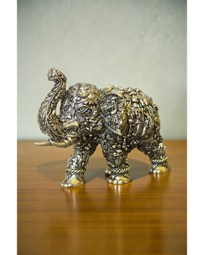 Rigvedaa brass elephant statue with intricate Radha Krishna murals, golden finish, detailed craftsmanship for puja and decor.
