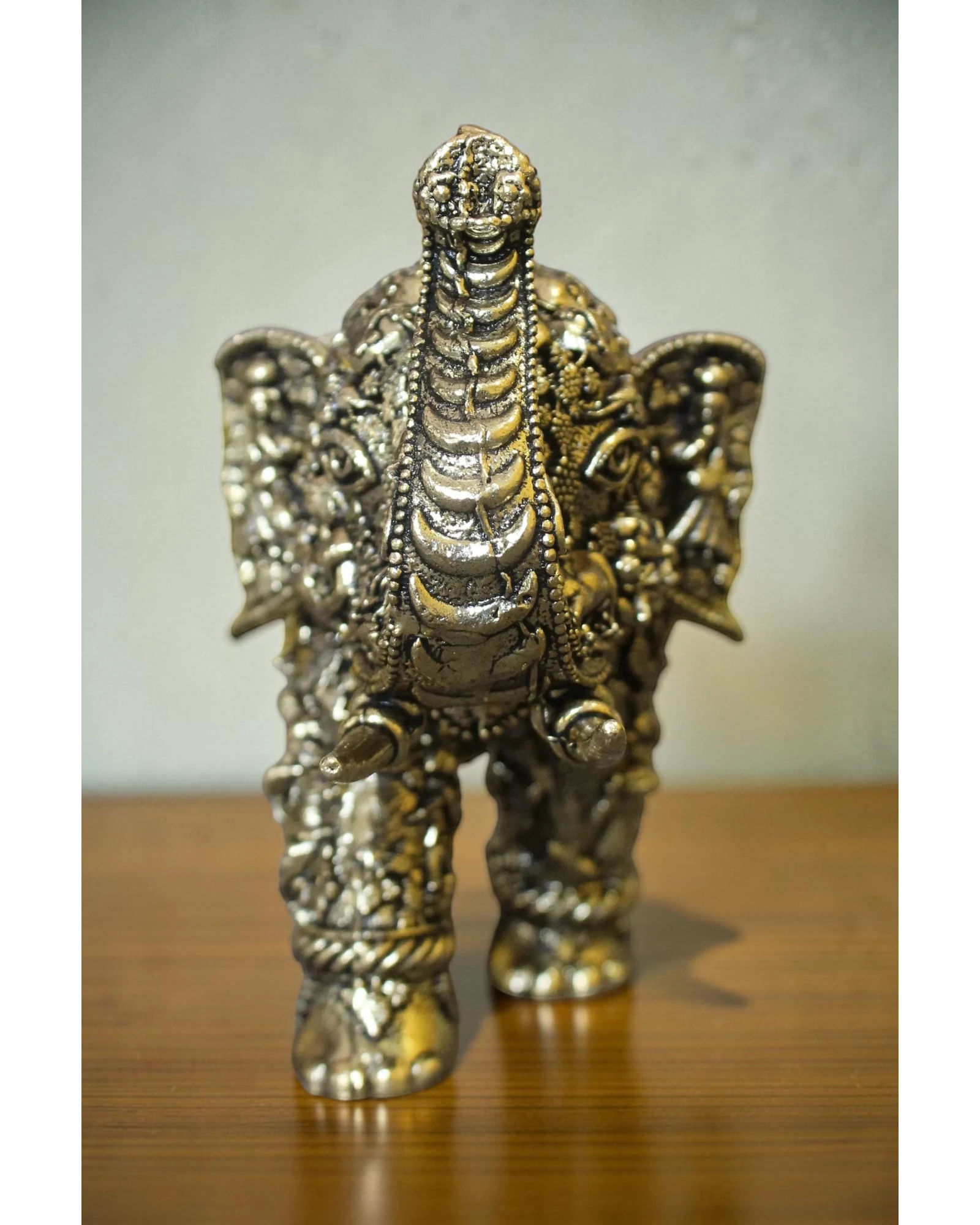 Rigvedaa brass elephant statue with intricate Radha Krishna murals, golden finish, for puja and decor.