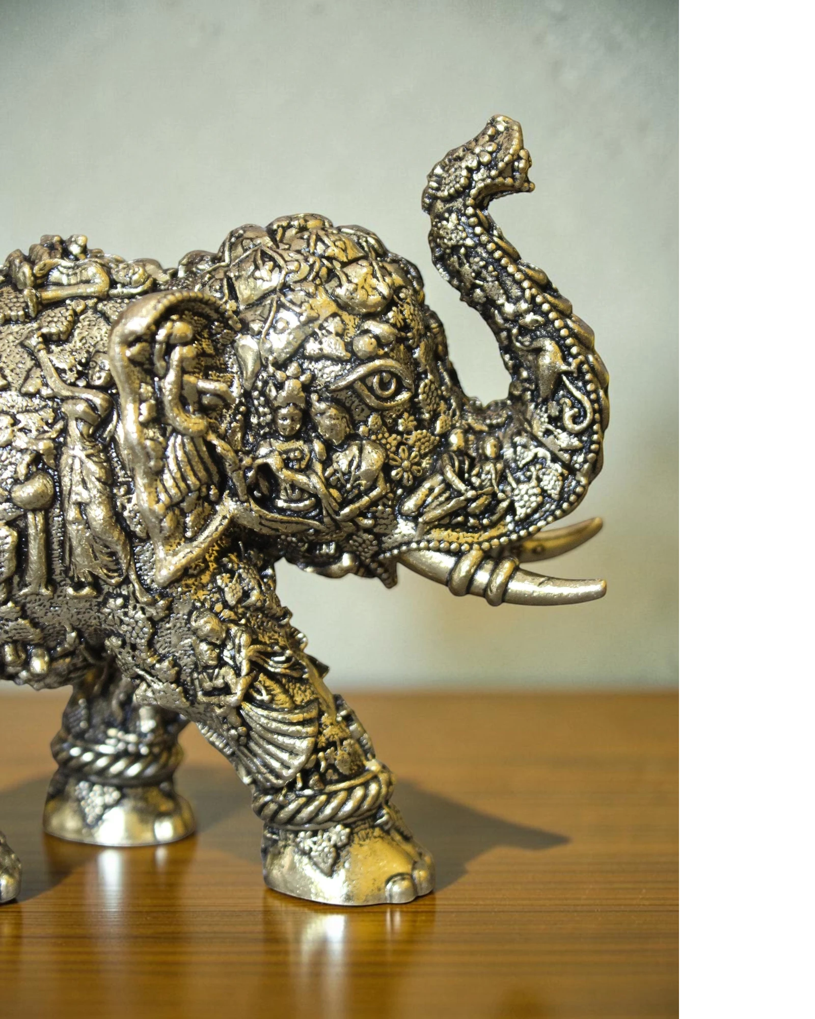 Rigvedaa brass elephant statue with intricate Radha Krishna murals, golden finish, for puja and decor.
