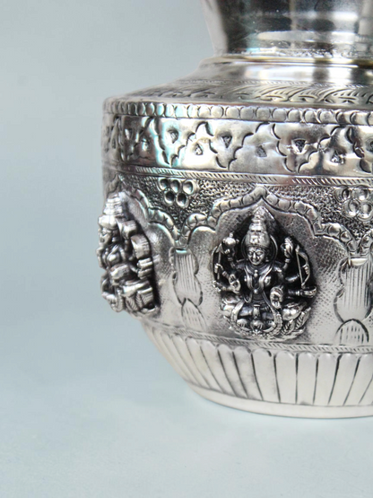 Rigvedaa™ 999 silver plated brass Ashta Lakshmi kalash featuring intricate embossed deities and floral motifs