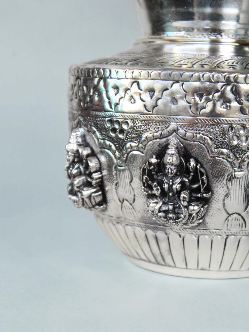 Rigvedaa™ 999 silver plated brass Ashta Lakshmi kalash featuring intricate embossed deities and floral motifs