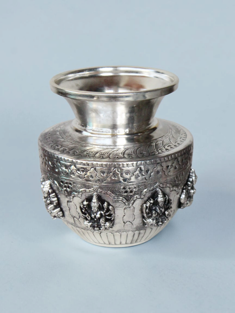 Rigvedaa™ 999 silver plated brass Ashta Lakshmi Kalash with intricate embossed floral and deity relief designs.