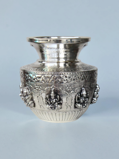 Rigvedaa™ 999 silver plated brass Ashta Lakshmi Kalash with intricate embossed floral and deity relief designs.