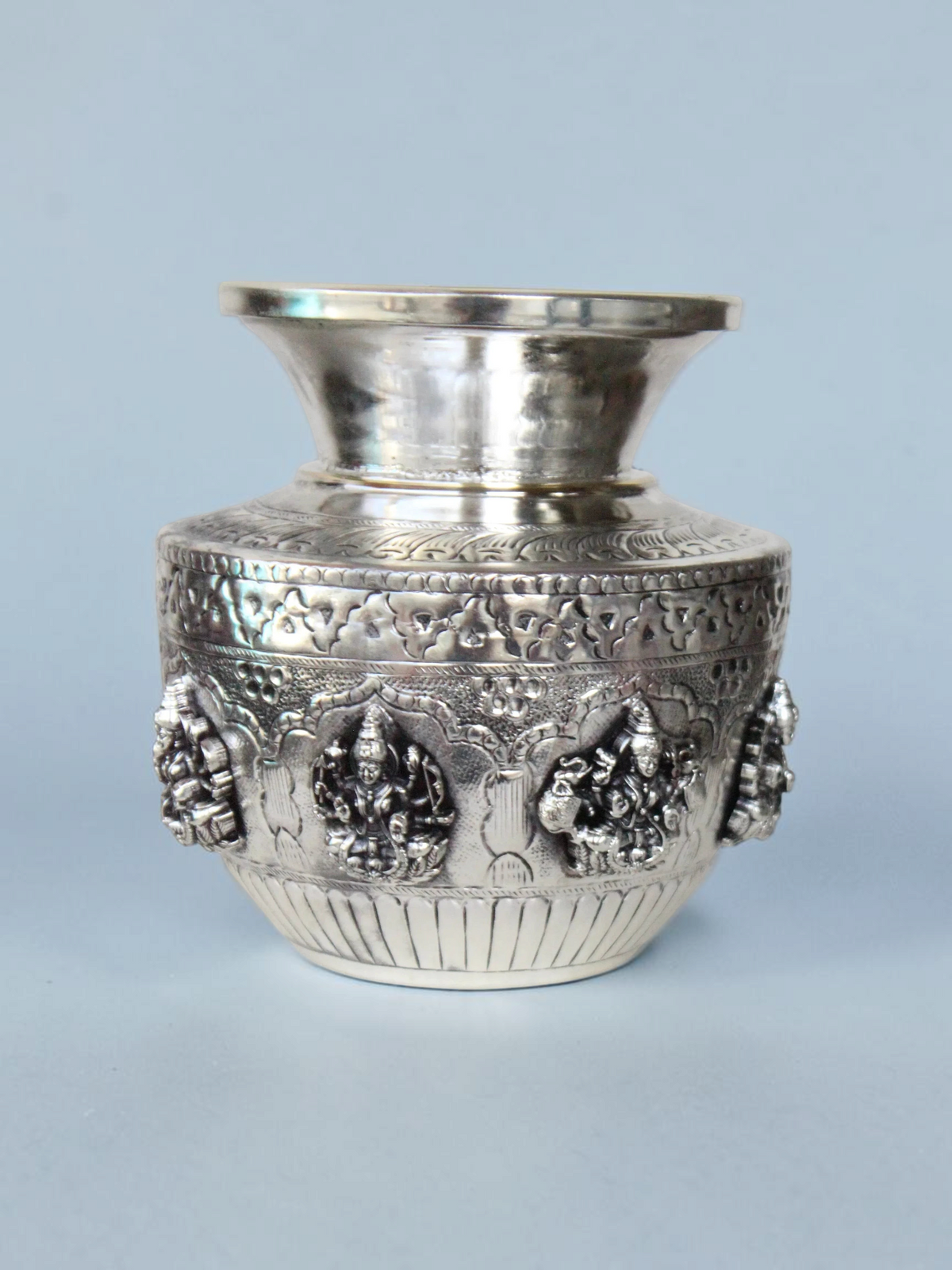 Rigvedaa™ 999 silver plated brass Ashta Lakshmi Kalash with intricate embossed floral and deity relief designs.