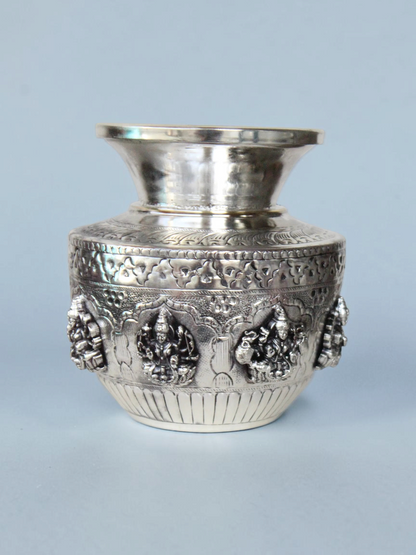 Rigvedaa™ 999 silver plated brass Ashta Lakshmi Kalash with intricate embossed floral and deity relief designs.