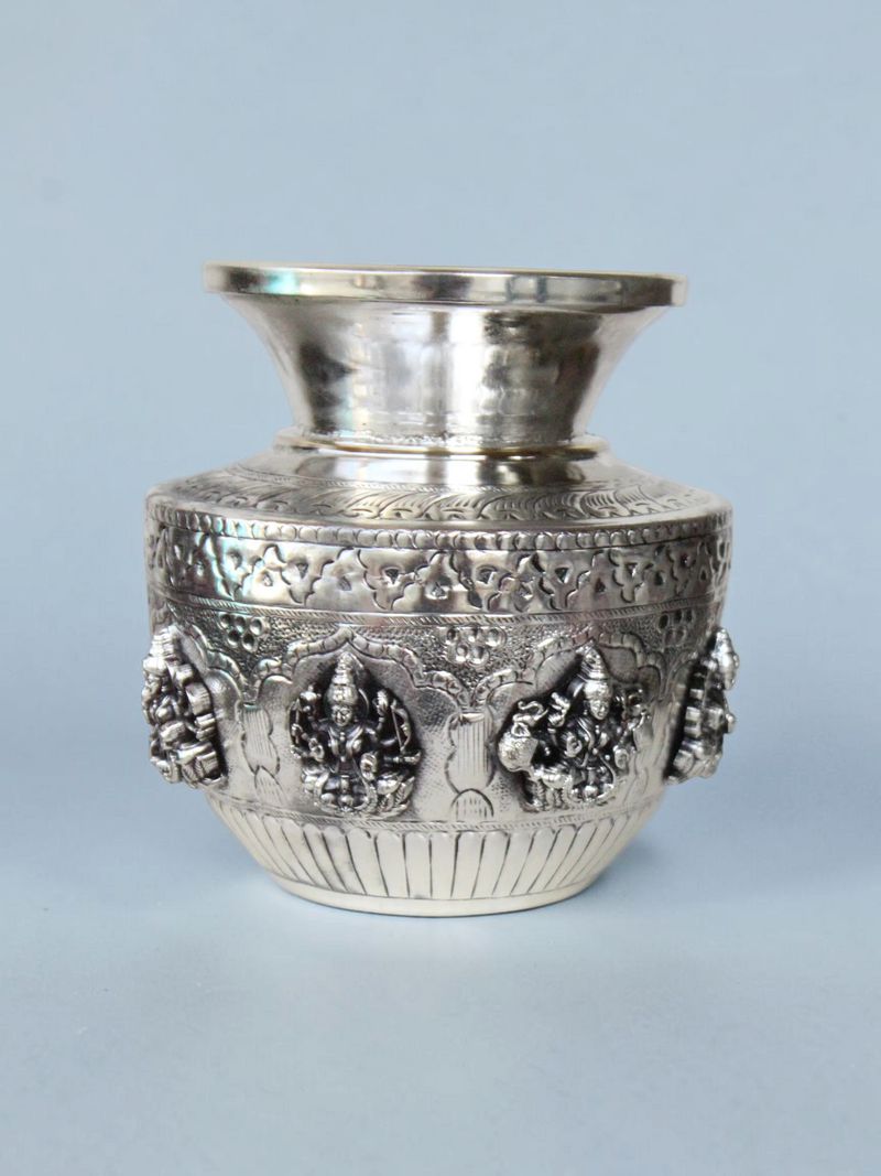 Rigvedaa™ 999 silver plated brass Ashta Lakshmi Kalash with intricate embossed floral and deity relief designs.