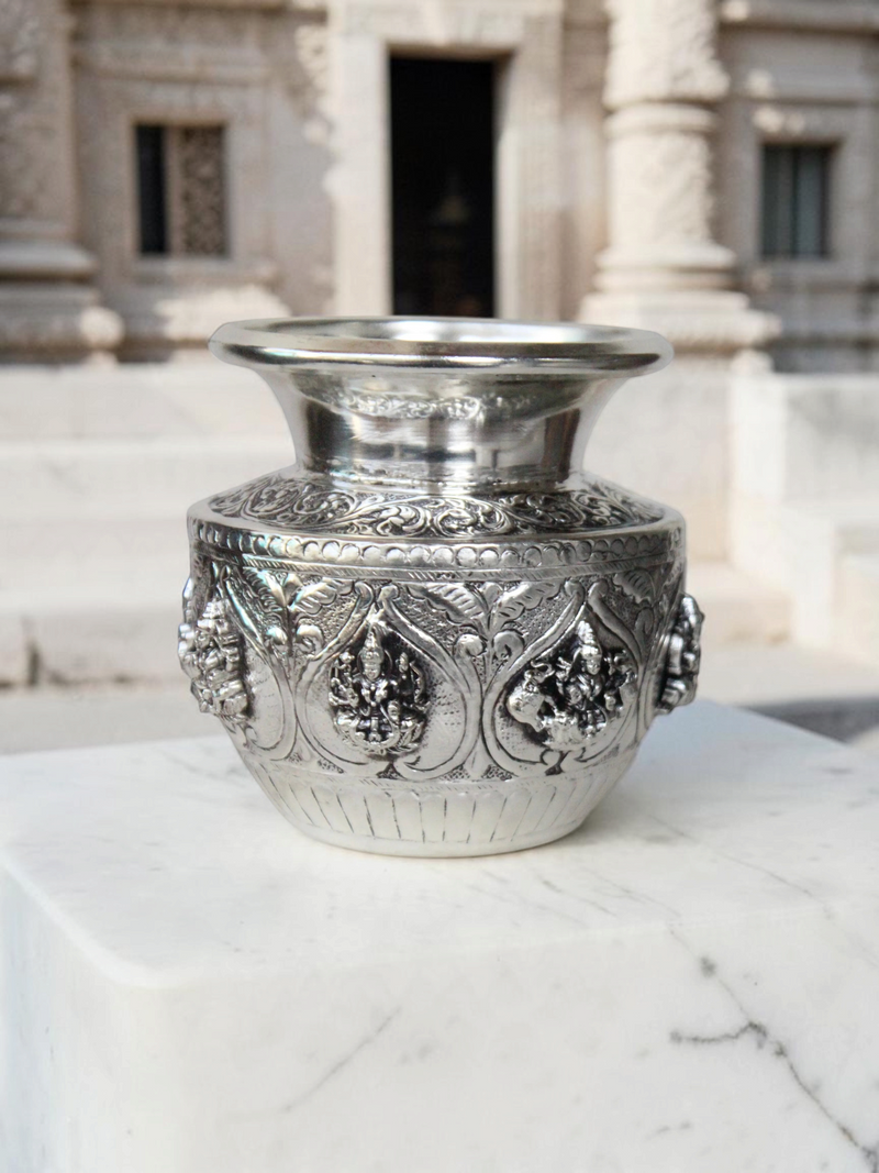 Rigvedaa™ 999 silver plated brass Ashta Lakshmi Kalash with intricate embossed floral and deity relief for pooja