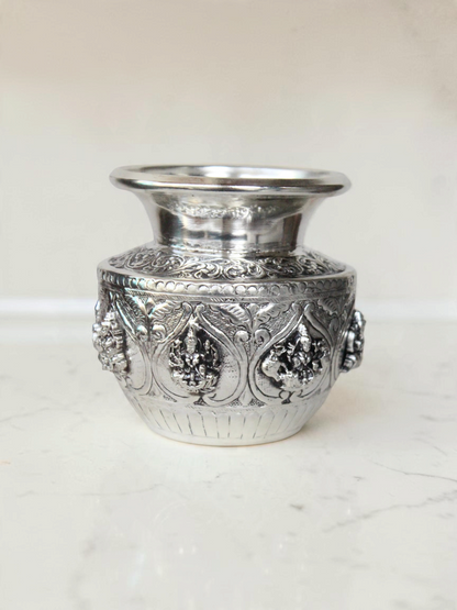 Rigvedaa™ 999 silver plated brass Ashta Lakshmi Kalash with intricate embossed floral and deity relief designs.