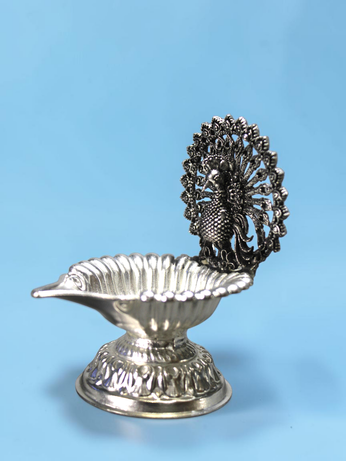 Rigvedaa™ silver plated brass peacock diya oil lamp with intricate lotus petal bowl for pooja and festive decor