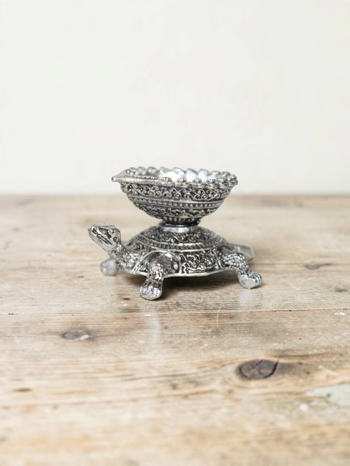 Rigvedaa™ silver-toned turtle diya oil lamp holder with intricate traditional metalwork detailing